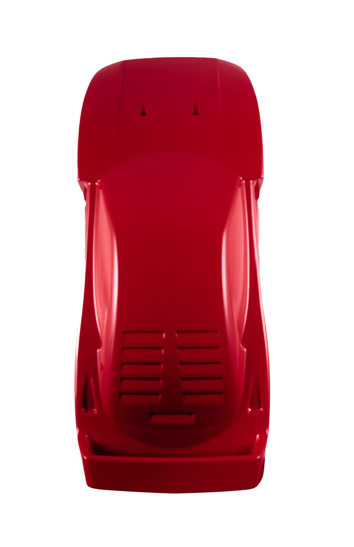 ‘Ferrari F40’ by Srini Gandra, a limited-edition contemporary automotive sculpture from the Forme di Velocità series, inspired by the legendary Ferrari F40, the final Ferrari personally approved by Enzo Ferrari. Presented in a striking high-gloss Rosso Corsa red finish, the sculpture captures the supercar's low wedge-shaped profile, sculpted bonnet, aerodynamic side intakes, distinctive rear engine vents and iconic elevated rear wing. Its smooth, minimalist surfaces celebrate the raw performance, aerodynami