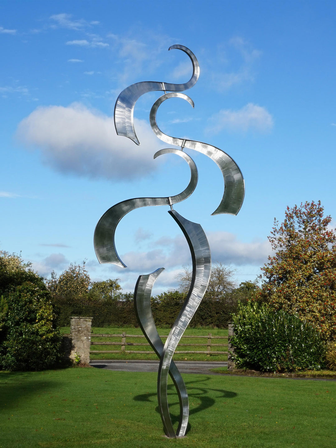 Abstract stainless steel kinetic sculpture with flowing, curved forms designed to move with the wind