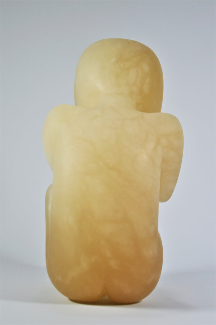 Deborah Harrison alabaster sculpture Foetus, one-off hand-carved work in translucent champagne alabaster, depicting a curled unborn child in the womb-like position, with soft organic form and warm golden glow, symbolising life, vulnerability, and spiritual beginnings.