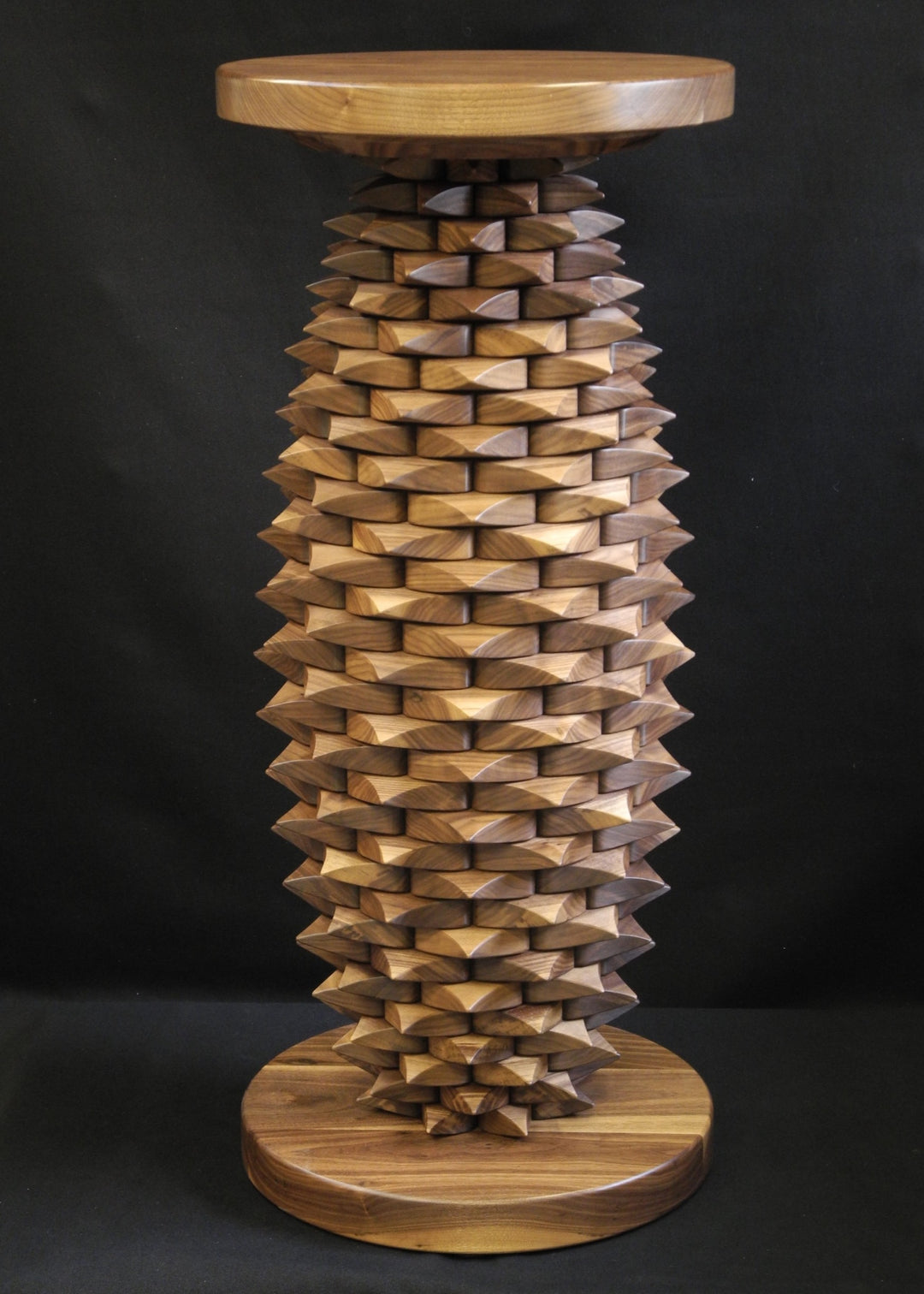 Fractal Table in black walnut by Max McCance, a one-off sculptural design with meticulously stacked linear components forming a rhythmic geometric column, blending precision mathematics with organic craftsmanship.