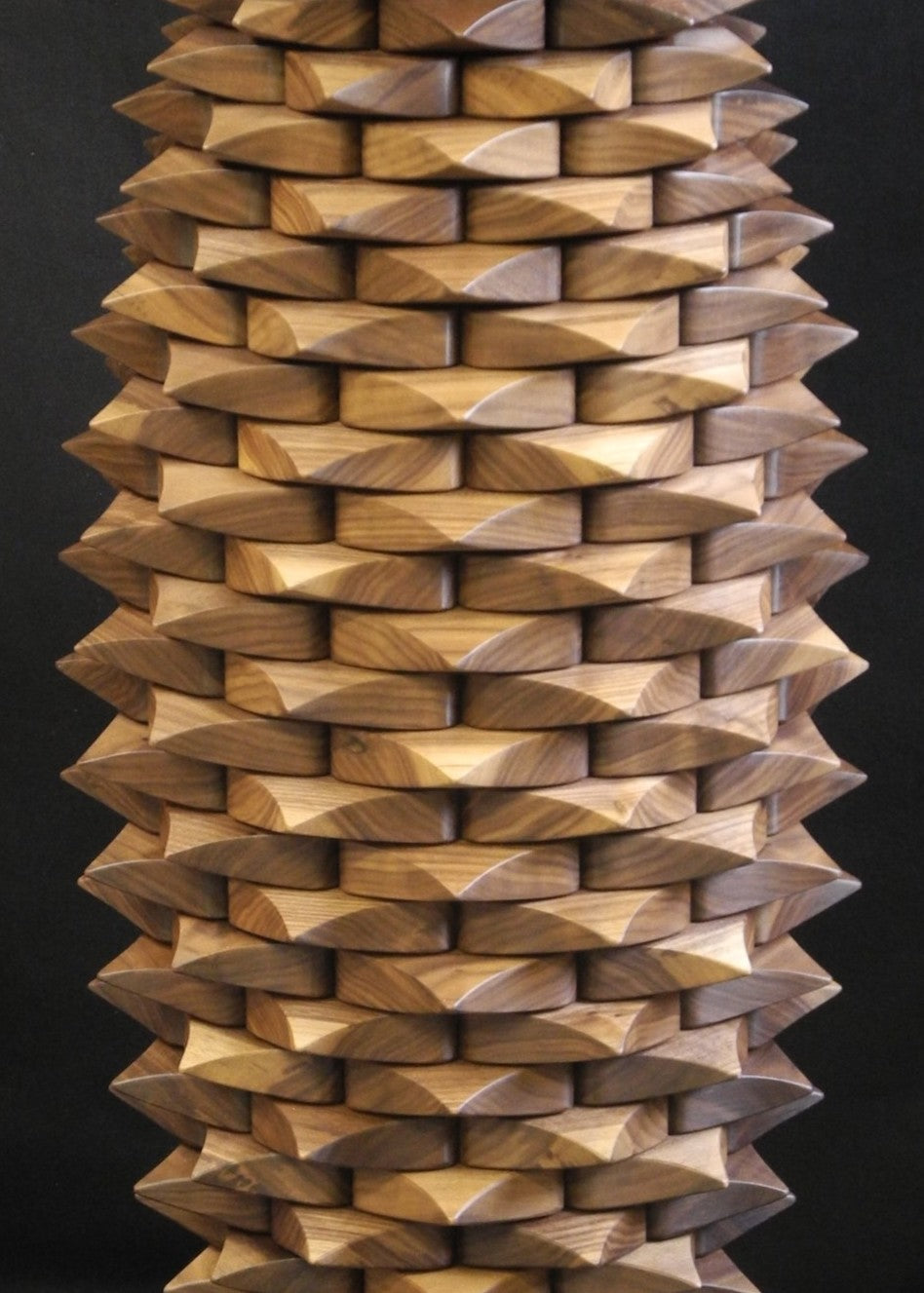 Fractal Table in black walnut by Max McCance, a one-off sculptural design with meticulously stacked linear components forming a rhythmic geometric column, blending precision mathematics with organic craftsmanship.