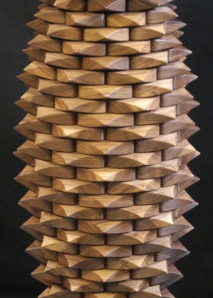 Fractal Table in black walnut by Max McCance, a one-off sculptural design with meticulously stacked linear components forming a rhythmic geometric column, blending precision mathematics with organic craftsmanship.