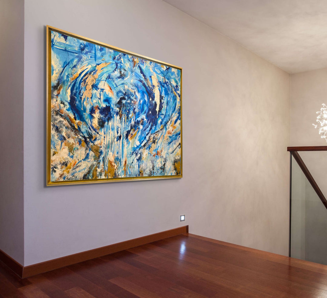 Highly textured blue and gold abstract painting with sweeping circular motion, cascading drips and layered brushstrokes, evoking water, movement and freedom, framed in a gold tray frame.