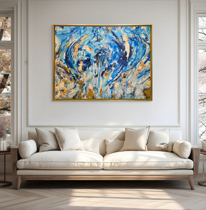 Highly textured blue and gold abstract painting with sweeping circular motion, cascading drips and layered brushstrokes, evoking water, movement and freedom, framed in a gold tray frame.