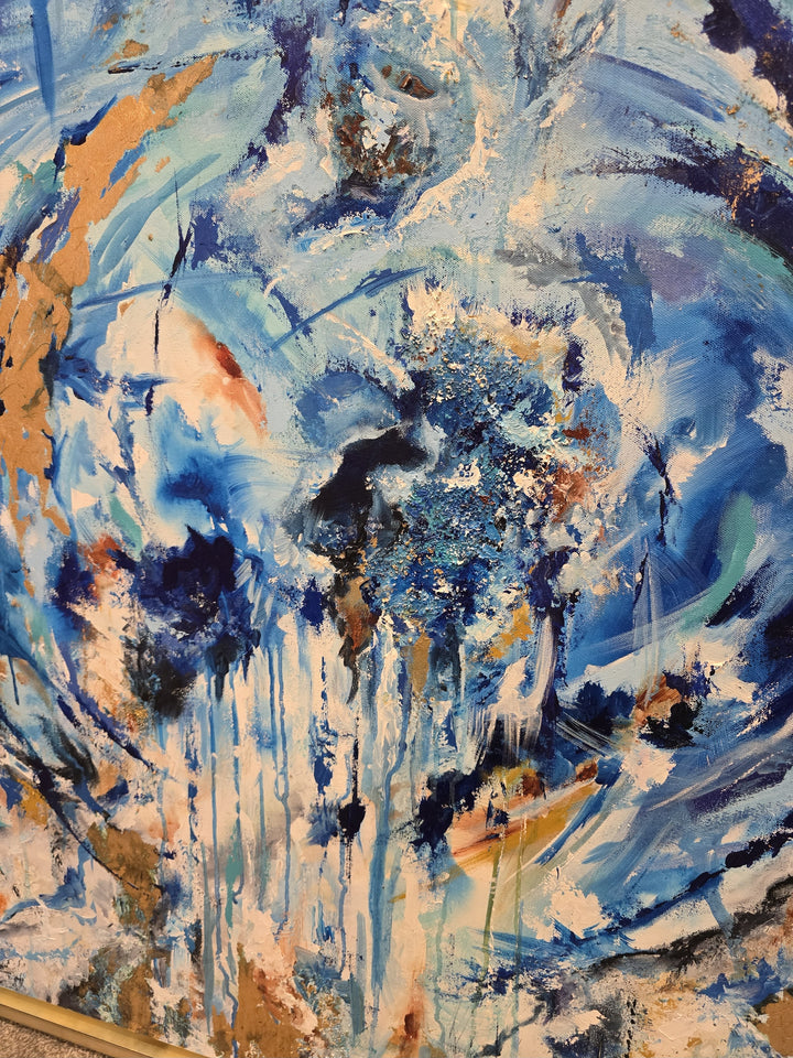 Highly textured blue and gold abstract painting with sweeping circular motion, cascading drips and layered brushstrokes, evoking water, movement and freedom, framed in a gold tray frame.