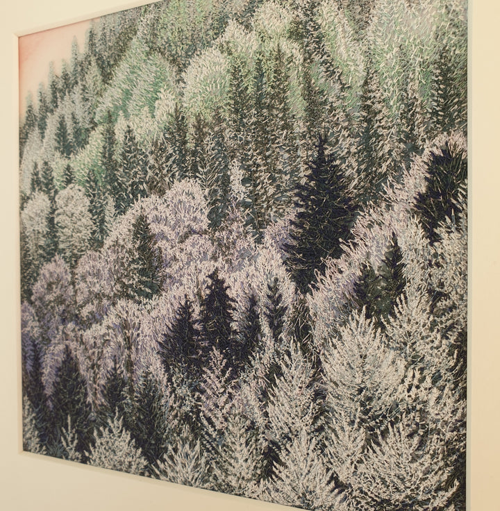 Layered embroidered forest scene with dense pine trees in muted shades of lavender, green, and deep navy thread.
