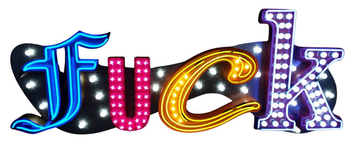 Chris Bracey, neon man, master of glow, gods own junkyard, Illuminated neon sign spelling out an expletive in bold, stylised letters — each letter lit in different colours and styles, including blue script, pink block lights, yellow cursive, and white marquee bulbs, mounted against a dark backdrop.