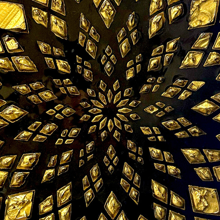 Bold circular wall artwork by Mike Philp with gold leaf geometric patterns radiating across a deep black ground. The high-gloss resin finish enhances light, depth, and precision, giving the piece a refined, architectural presence.