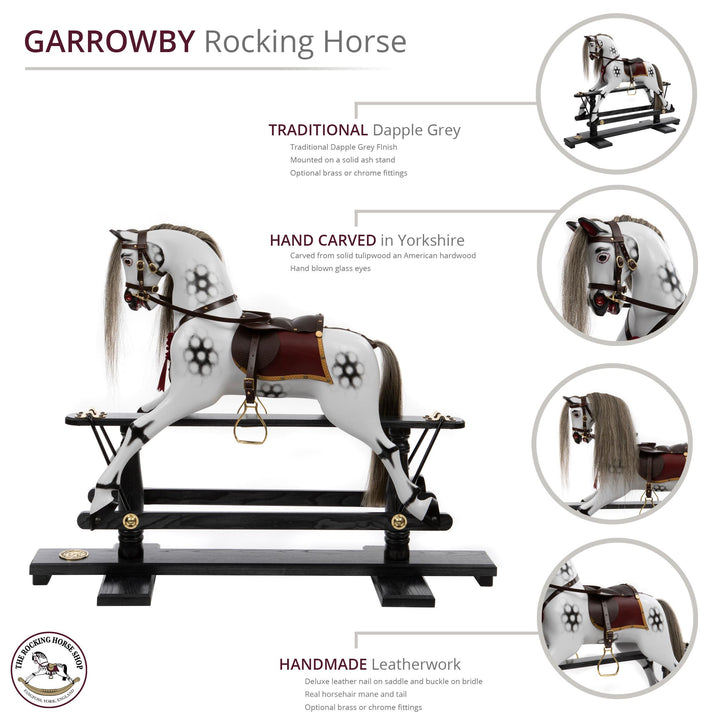 White rocking horse with stylised black dapples, grey mane, and rich burgundy leather tack on a polished oak safety stand.

