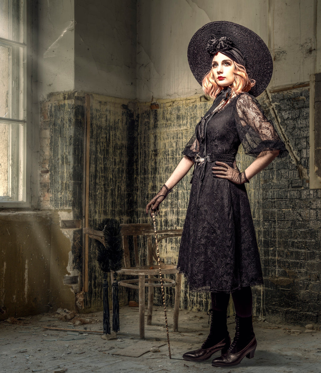 A poised woman in an elegant black lace dress, hat, and gloves stands confidently in a decaying, abandoned room. With a decorative cane in hand and sunlight filtering through a broken window, the image contrasts refined Victorian elegance against textured urban decay, evoking a sense of timeless resilience and theatrical flair.