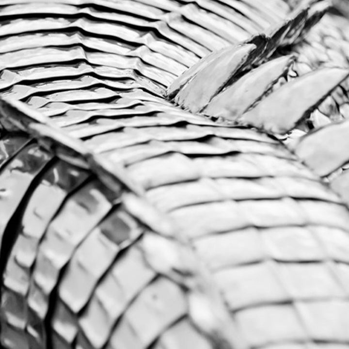 ‘Crocodile on a Box’ by Michael Turner, a unique, one-of-one stainless steel wildlife sculpture depicting a life-size crocodile resting across a large wooden crate. Handcrafted from intricately shaped and welded stainless steel, the crocodile features individually detailed silver scales, powerful jaws, raised ridges along its back, muscular legs and a long tail extending over the edge. The rustic brown timber box features a metal hatch, locking mechanism and bold black DANGER lettering, creating a striking 