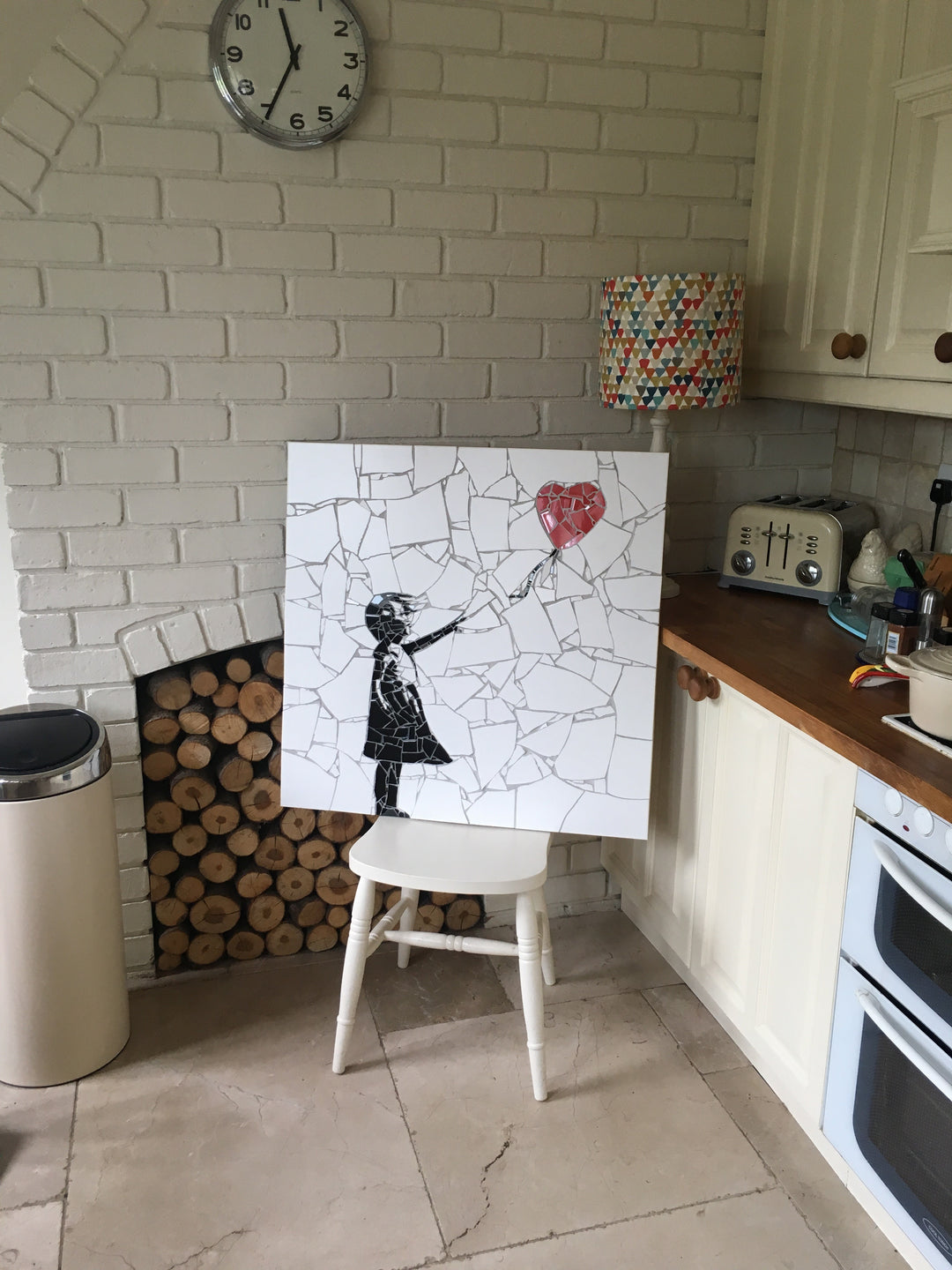 “Girl with Balloon” mosaic — a handcrafted ceramic tile artwork reimagining the iconic heart balloon image. Featuring black and white tiles with a vivid red heart, this bespoke commission blends street art symbolism with fine mosaic craftsmanship.