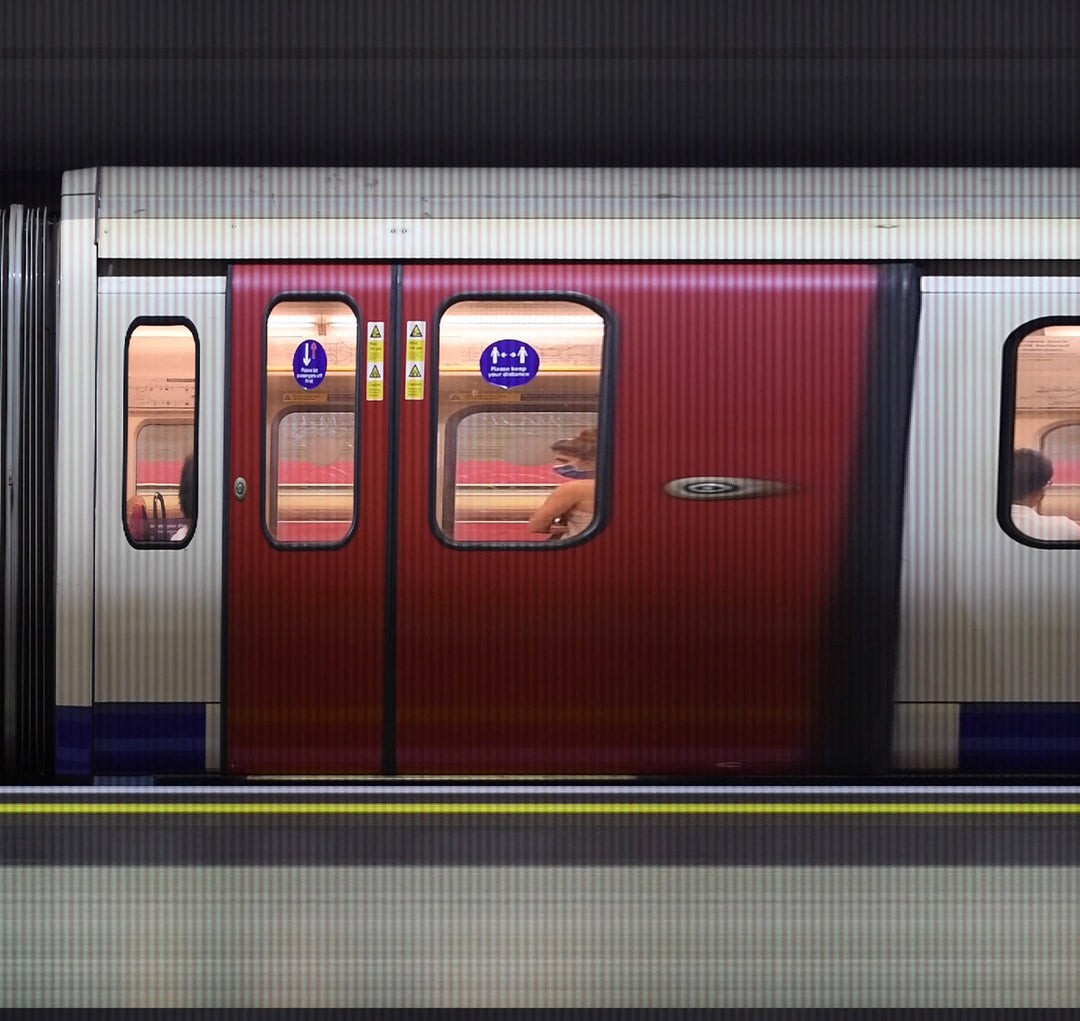 A high-speed reconstructed video print capturing the movement of London Underground trains at Gloucester Road Station. Strips of colour blur horizontally, representing the pulse of the city as it emerges from the COVID-19 pandemic—blending abstraction, motion, and structure into a visual rhythm of urban life.