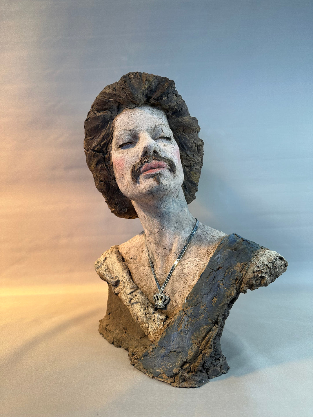 Contemporary ceramic bust sculpture by Eve Shepherd featuring a raw hand-built female figure wearing a mirrored mosaic crown, combining classical portraiture with modern satire, textured clay surfaces, reflective glass elements and irreverent royal symbolism