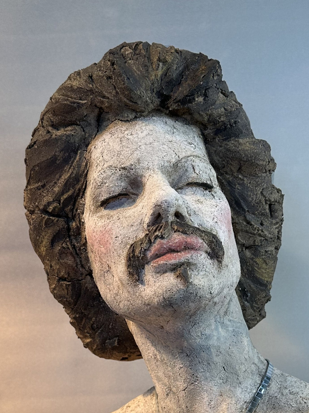 Contemporary ceramic bust sculpture by Eve Shepherd featuring a raw hand-built female figure wearing a mirrored mosaic crown, combining classical portraiture with modern satire, textured clay surfaces, reflective glass elements and irreverent royal symbolism