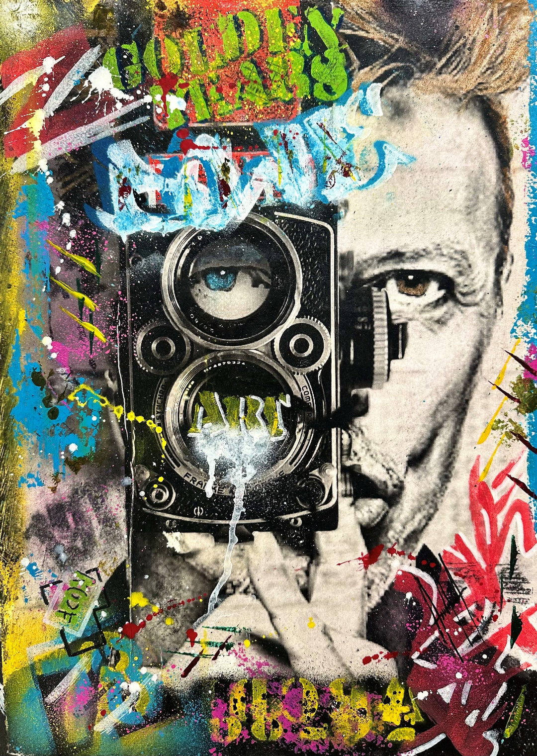 “Golden Years by Andolini Art – mixed media on paper artwork of David Bowie holding a vintage camera, with one lens replaced by a blue eye and the word ART stencilled, layered with graffiti, stencil, and bold splashes of red, yellow, blue and green.”