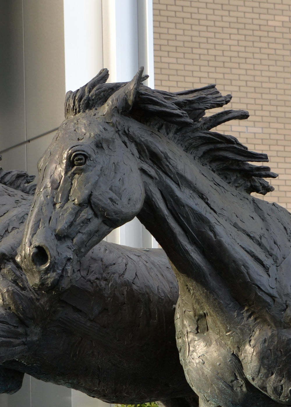 ‘Goodman's Horses Running Together’ by Hamish Mackie, a monumental limited-edition bronze sculpture depicting two powerful horses, a thoroughbred and a shire-cross, galloping together through water. Originally commissioned for Goodman's Fields in London, the dynamic public artwork captures muscular movement, flowing manes and the energy of horses in motion, finished in dark patinated bronze.