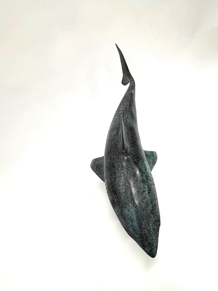 Bronze sculpture of a shark captured mid-motion, mounted on a textured base and finished in a deep mottled patina, cast as a limited edition artwork.