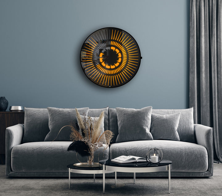“Tempus Obsidian” by Ben Rousseau – a limited-edition illuminated wall timepiece crafted from grey mirrored glass and brass-tinted aluminium with LEDs. Inspired by obsidian, it radiates calm through subtle light and refined design.

