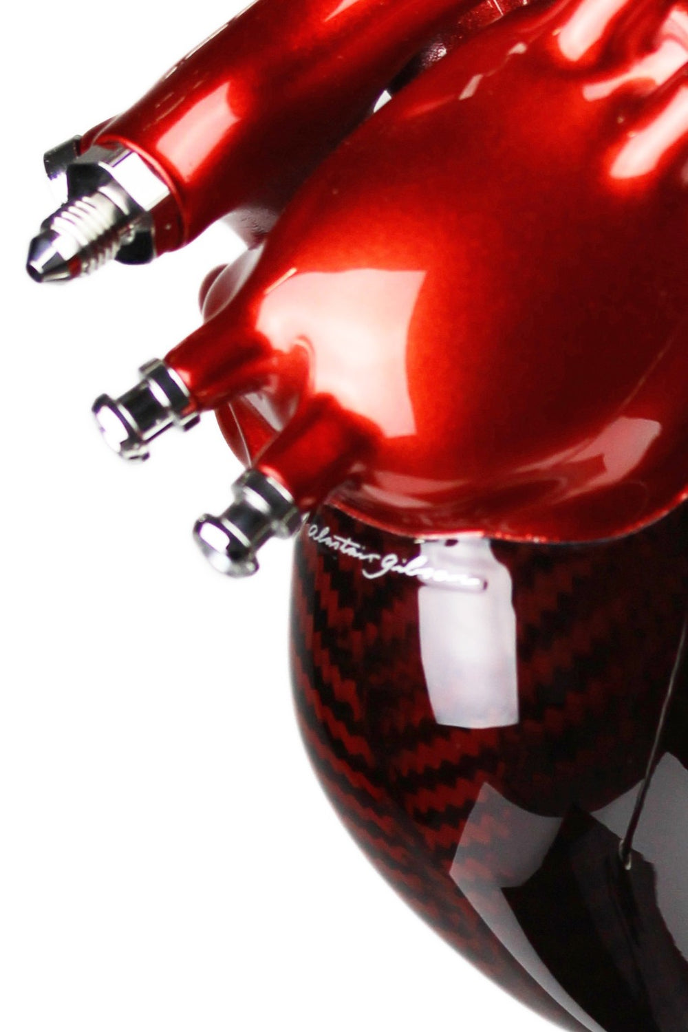 A vivid heart sculpture by Alastair Gibson, crafted from red-tinted 2x2 twill carbon fibre and finished with 3D-printed ABS atriums. Featuring titanium fuel and hydraulic fittings from Grand Prix cars, it fuses organic form with motorsport engineering. Finished in deep racing red with a UV-resistant gloss, it’s desk-mounted on a polished granite base with a stainless steel hydraulic support—blending precision with striking visual impact.