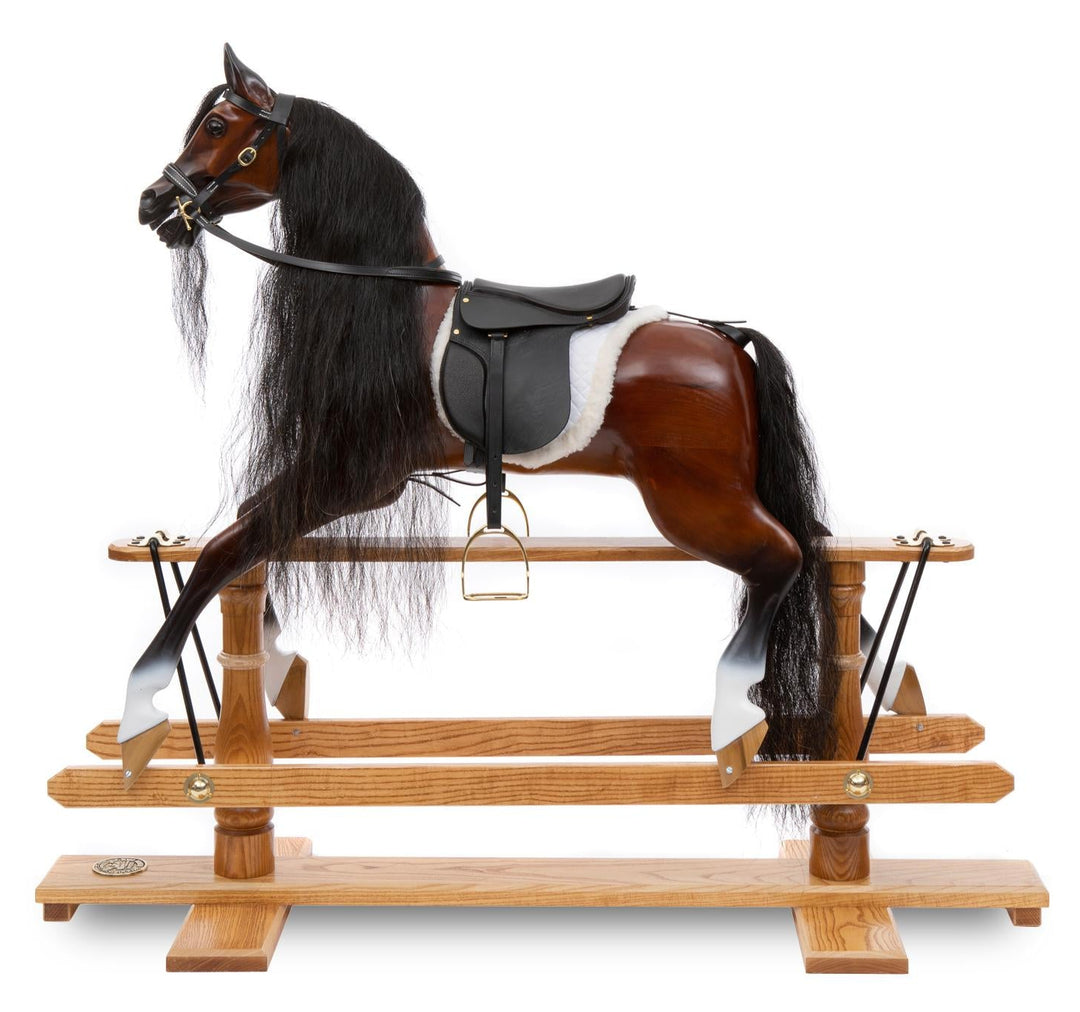 Glossy dark wood rocking horse with flowing black mane, black saddle, and white sheepskin numnah on a traditional oak safety stand.

