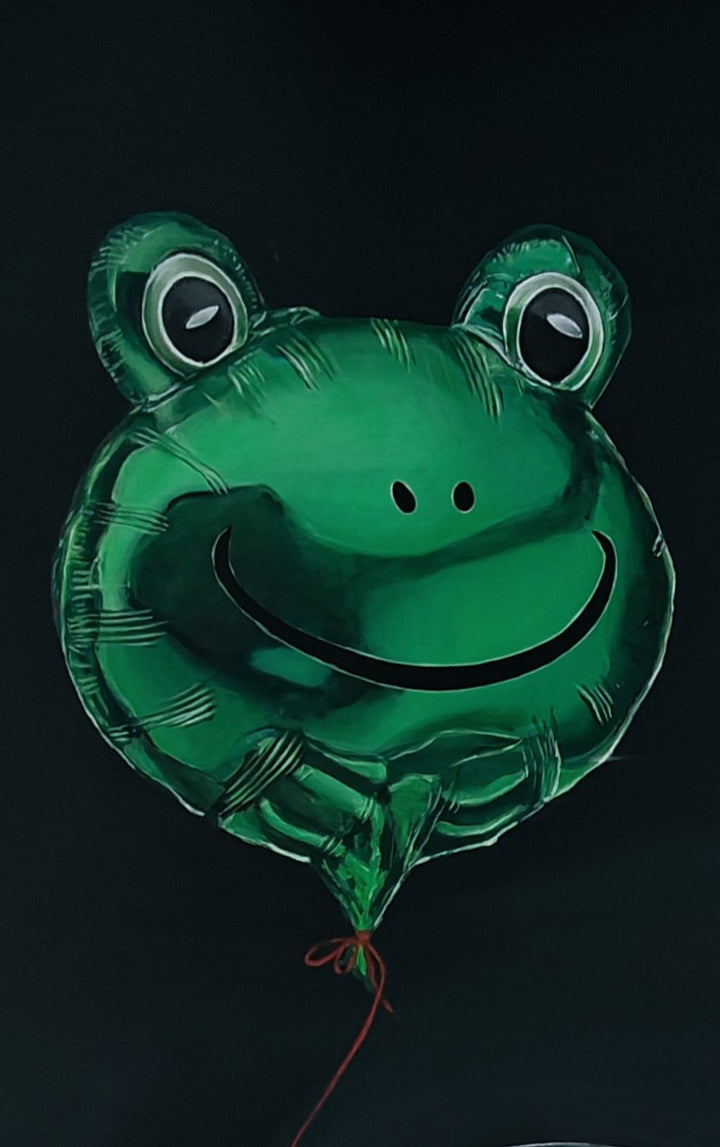 Hyper-realistic painting of a classic British racing green Aston Martin DB3S front-on against a deep black background, with a shiny metallic green frog-shaped balloon floating above the car, its red string tied to the vehicle — a playful contrast of automotive heritage and childlike whimsy.