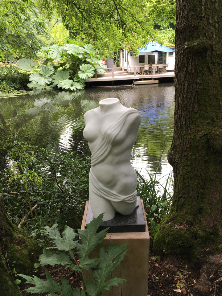 Lucy Unwin marble sculpture Venus, hand carved from white Statuary Carrara marble, depicting a contemporary female torso partially wrapped in flowing carved drapery with smooth figurative contours and finely detailed folds.