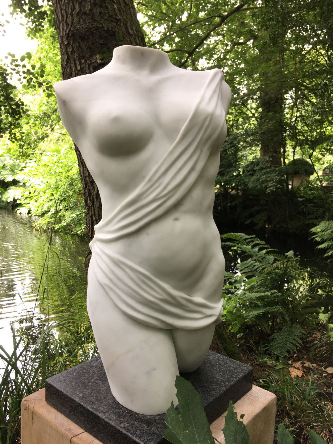 Lucy Unwin marble sculpture Venus, hand carved from white Statuary Carrara marble, depicting a contemporary female torso partially wrapped in flowing carved drapery with smooth figurative contours and finely detailed folds.