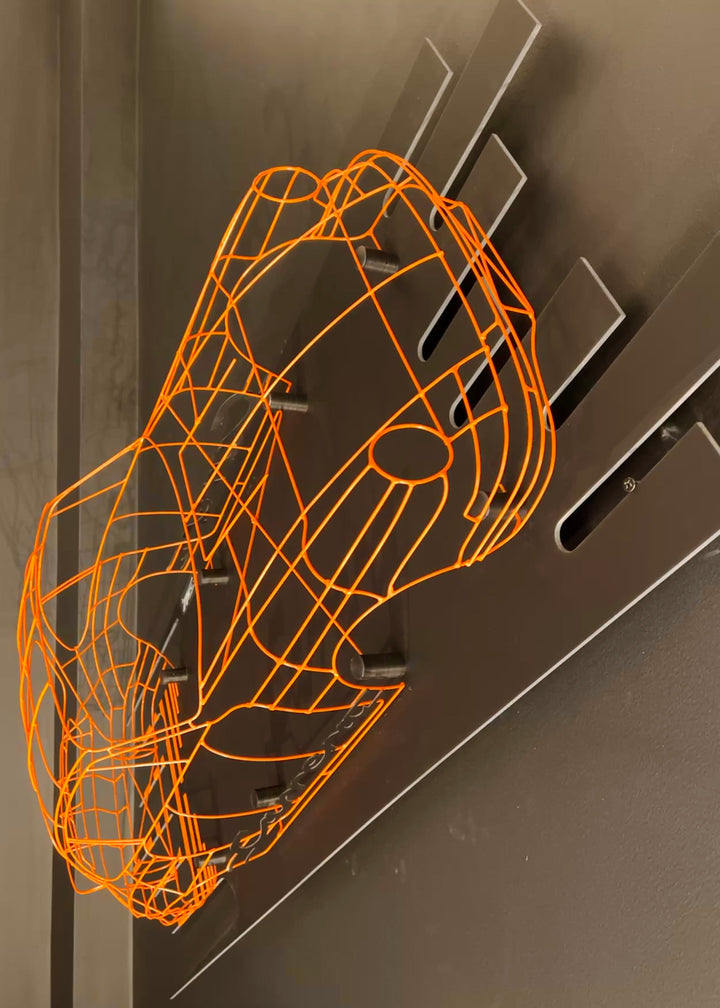 Handcrafted Porsche 911 2.7 RS wire sculpture by Chris Twitchell, finished in vivid Tangerine orange with black Carrera script. This detailed artwork captures the iconic pre-impact bumper 911 form — from its classic round headlights to the signature ducktail spoiler — reimagined as a precision-engineered wireframe sculpture that celebrates Porsche’s timeless design and performance heritage.