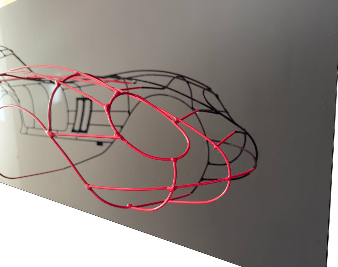 Handcrafted Ferrari 250 GTO wire sculpture by Chris Twitchell, capturing the elegant profile of the legendary 1962 Series 1 Scaglietti body. Finished in Rosso Chiaro red and mounted on a sleek black panel, this sculptural study reimagines the original Maranello buck in minimalist wire form — a fusion of precision engineering, Italian design, and contemporary British craftsmanship.