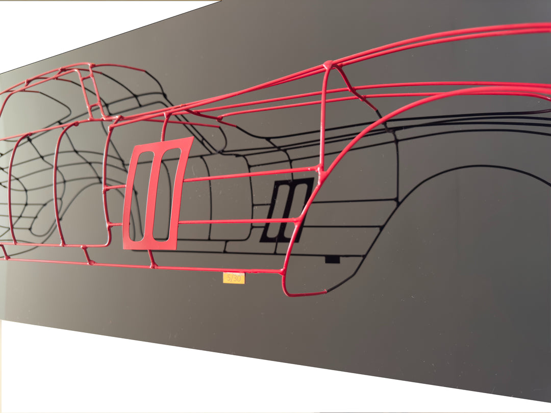 Handcrafted Ferrari 250 GTO wire sculpture by Chris Twitchell, capturing the elegant profile of the legendary 1962 Series 1 Scaglietti body. Finished in Rosso Chiaro red and mounted on a sleek black panel, this sculptural study reimagines the original Maranello buck in minimalist wire form — a fusion of precision engineering, Italian design, and contemporary British craftsmanship.