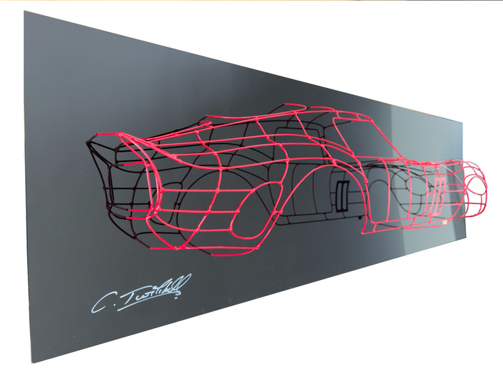 Handcrafted Ferrari 250 GTO wire sculpture by Chris Twitchell, capturing the elegant profile of the legendary 1962 Series 1 Scaglietti body. Finished in Rosso Chiaro red and mounted on a sleek black panel, this sculptural study reimagines the original Maranello buck in minimalist wire form — a fusion of precision engineering, Italian design, and contemporary British craftsmanship.