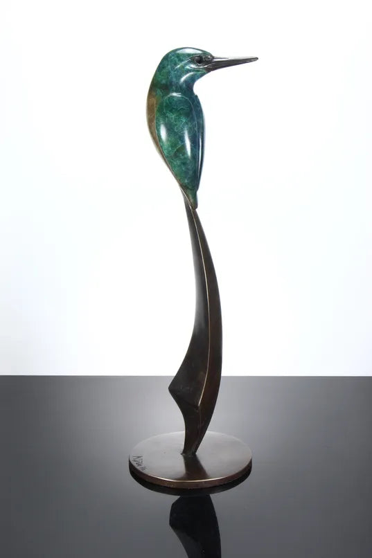Elegant bronze sculpture of a stylised kingfisher perched on a tall, curved base. The bird features a vivid patina in shades of emerald green and turquoise, with a rich brown lower half and dark bronze beak, all finished with a lustrous polish.