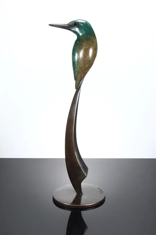 Elegant bronze sculpture of a stylised kingfisher perched on a tall, curved base. The bird features a vivid patina in shades of emerald green and turquoise, with a rich brown lower half and dark bronze beak, all finished with a lustrous polish.