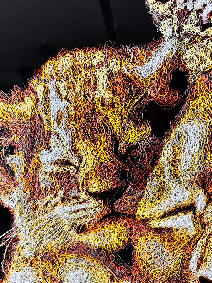 A richly textured injected-scribble artwork depicting a majestic lion wearing a crown, resting peacefully with three lion cubs nestled against him. The composition glows with warm tones of gold, amber, orange and cream, set against a deep black background that enhances the dimensional, thread-like detailing.