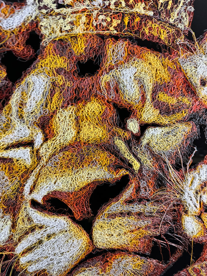 A richly textured injected-scribble artwork depicting a majestic lion wearing a crown, resting peacefully with three lion cubs nestled against him. The composition glows with warm tones of gold, amber, orange and cream, set against a deep black background that enhances the dimensional, thread-like detailing.