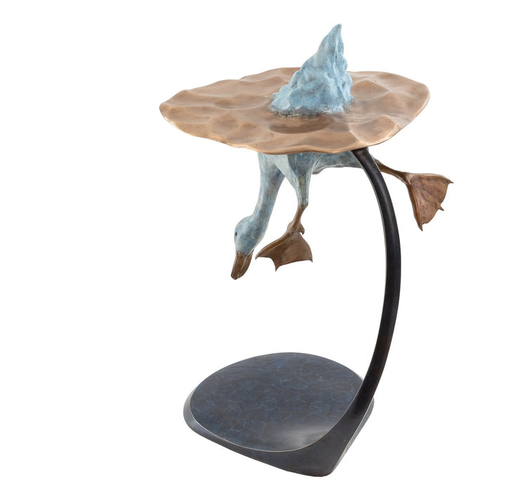 Playful bronze sculpture of a duck diving underwater, with only the rear and feet above a rippled surface, supported by a curved bronze stand — full of character and movement.