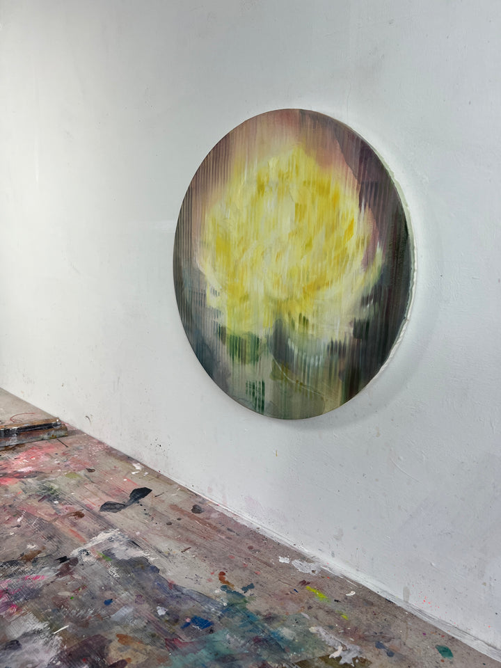 Abstract round painting of a yellow flower with blurred vertical texture on muted background.