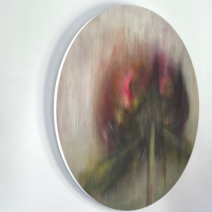 Abstract circular painting of a blurred flower with dark green and deep pink tones.