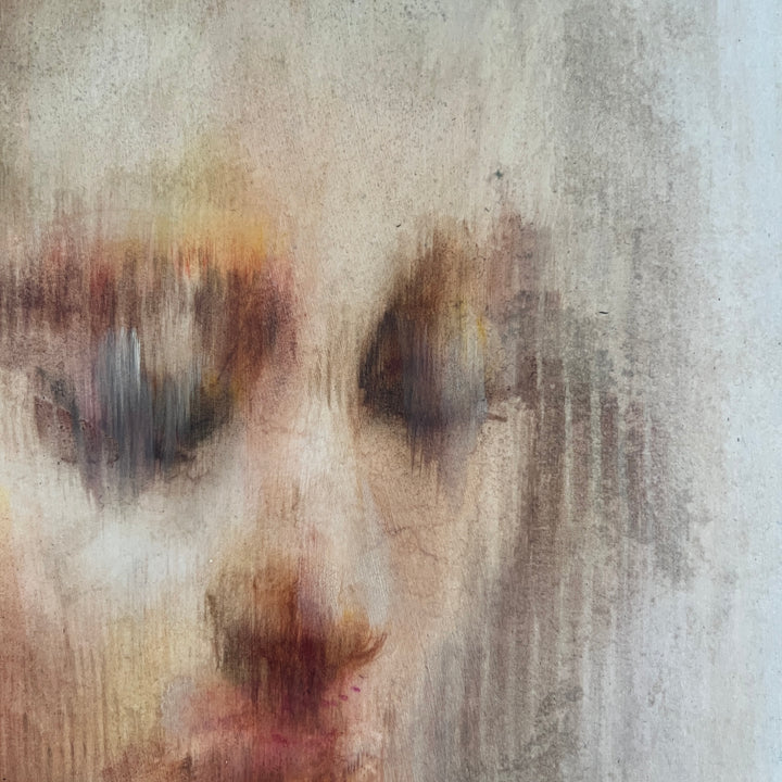 Soft-focus portrait of a pensive face with closed eyes in muted earthy tones on round canvas.