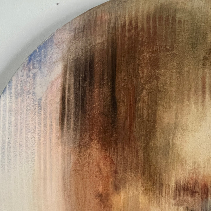 Soft-focus portrait of a pensive face with closed eyes in muted earthy tones on round canvas.