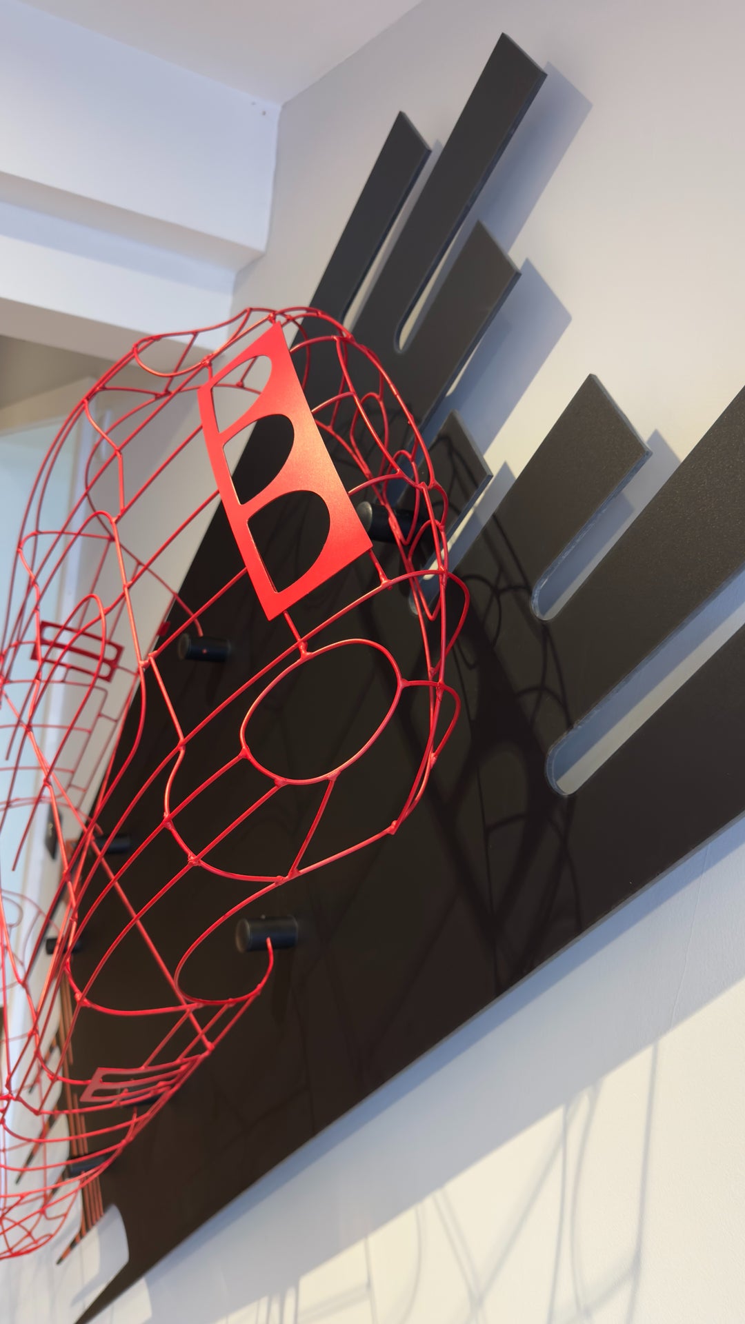 Handcrafted red wire sculpture of the Ferrari 250 GTO by Chris Twitchell, inspired by the original coachbuilder’s buck used to form the legendary 1962 Series 1 body. Finished in Rosso Chiaro red, this intricate wall-mounted artwork captures the elegance, form, and aerodynamics of Scaglietti’s design through sculptural craftsmanship and precision engineering.