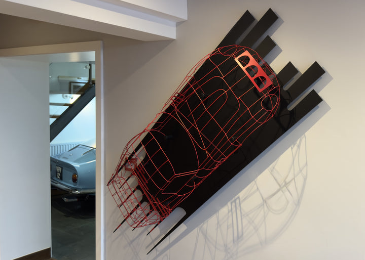 Handcrafted red wire sculpture of the Ferrari 250 GTO by Chris Twitchell, inspired by the original coachbuilder’s buck used to form the legendary 1962 Series 1 body. Finished in Rosso Chiaro red, this intricate wall-mounted artwork captures the elegance, form, and aerodynamics of Scaglietti’s design through sculptural craftsmanship and precision engineering.