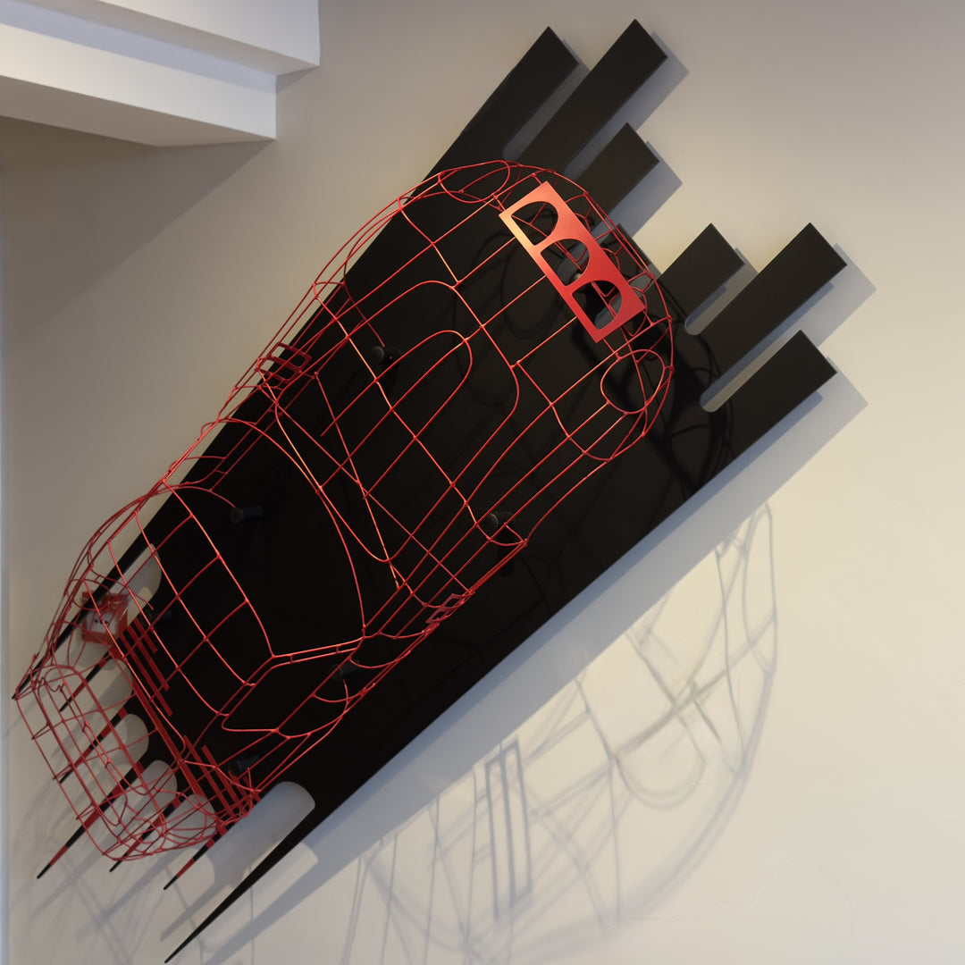 Handcrafted red wire sculpture of the Ferrari 250 GTO by Chris Twitchell, inspired by the original coachbuilder’s buck used to form the legendary 1962 Series 1 body. Finished in Rosso Chiaro red, this intricate wall-mounted artwork captures the elegance, form, and aerodynamics of Scaglietti’s design through sculptural craftsmanship and precision engineering.