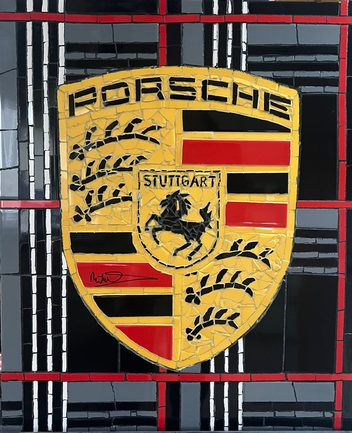 Two handcrafted ceramic mosaic wall artworks featuring Ferrari and Porsche badges, created as bespoke commissions. Each piece is made from hand-cut ceramic tiles in yellow, red, black, white, and grey, celebrating classic motorsport design and automotive heritage through contemporary mosaic craftsmanship.