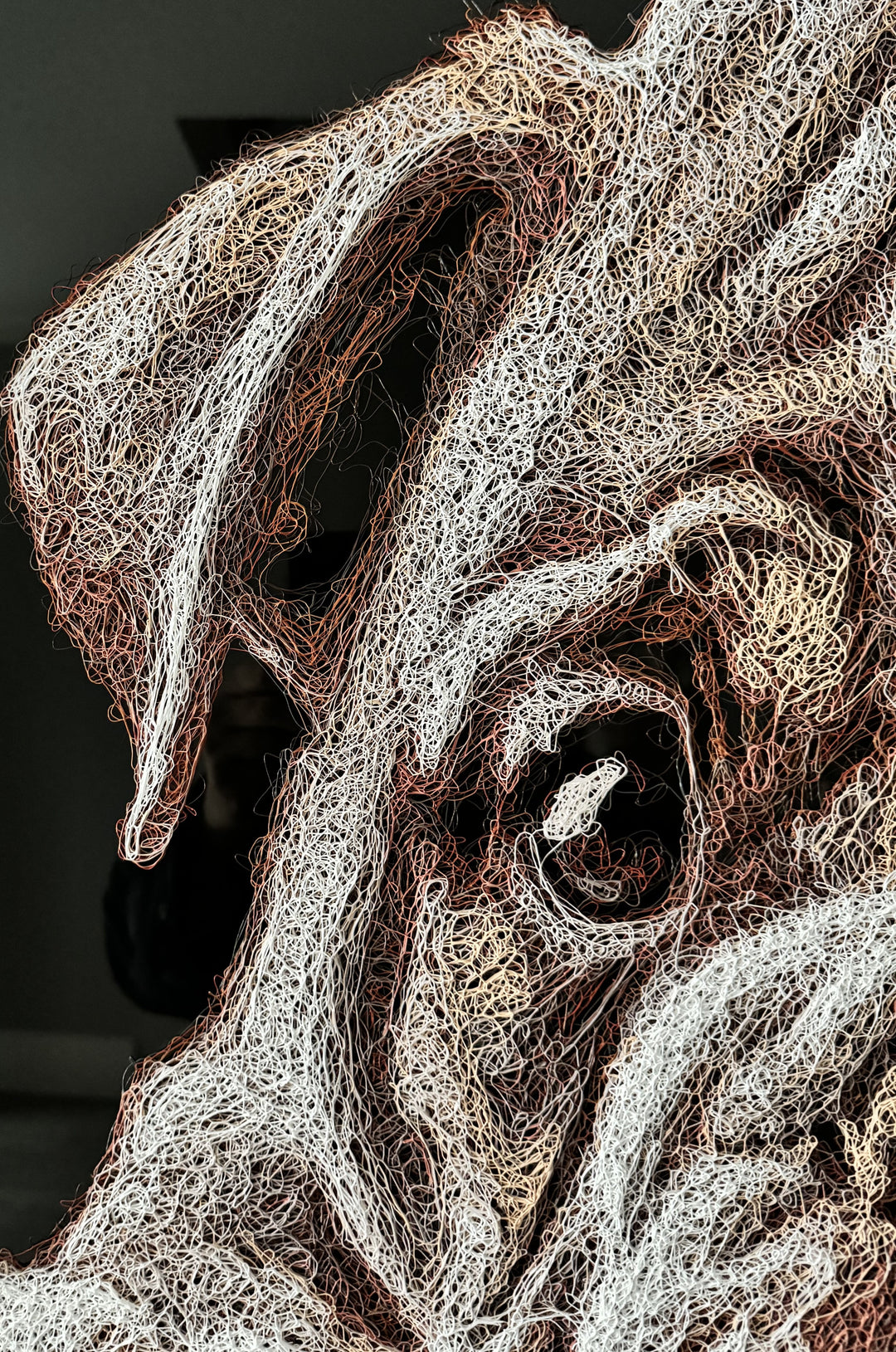 Vibrant injected-scribble artwork of a bulldog puppy resting at the edge of rippling water, its reflection distorted in swirling tones of white, tan, copper and brown, with dense textured linework creating a three-dimensional, energetic surface.