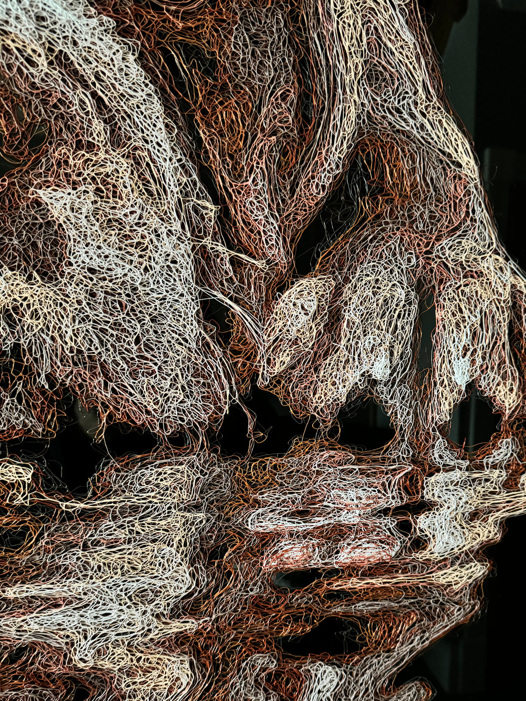 Vibrant injected-scribble artwork of a bulldog puppy resting at the edge of rippling water, its reflection distorted in swirling tones of white, tan, copper and brown, with dense textured linework creating a three-dimensional, energetic surface.