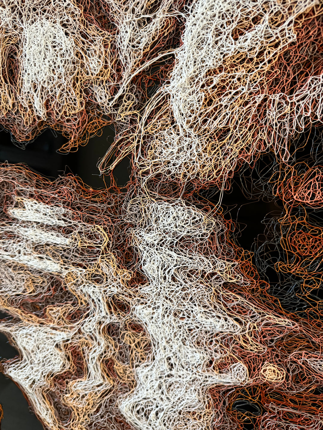 Vibrant injected-scribble artwork of a bulldog puppy resting at the edge of rippling water, its reflection distorted in swirling tones of white, tan, copper and brown, with dense textured linework creating a three-dimensional, energetic surface.