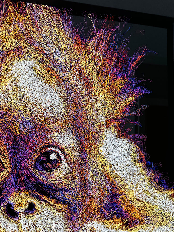 A vibrant textured artwork of a baby orangutan leaning over shimmering water, created with Zalini’s intricate injected-scribble technique, featuring flowing multicoloured lines, bright orange fur, vivid purples and blues, and a mirrored reflection across a glossy black surface.