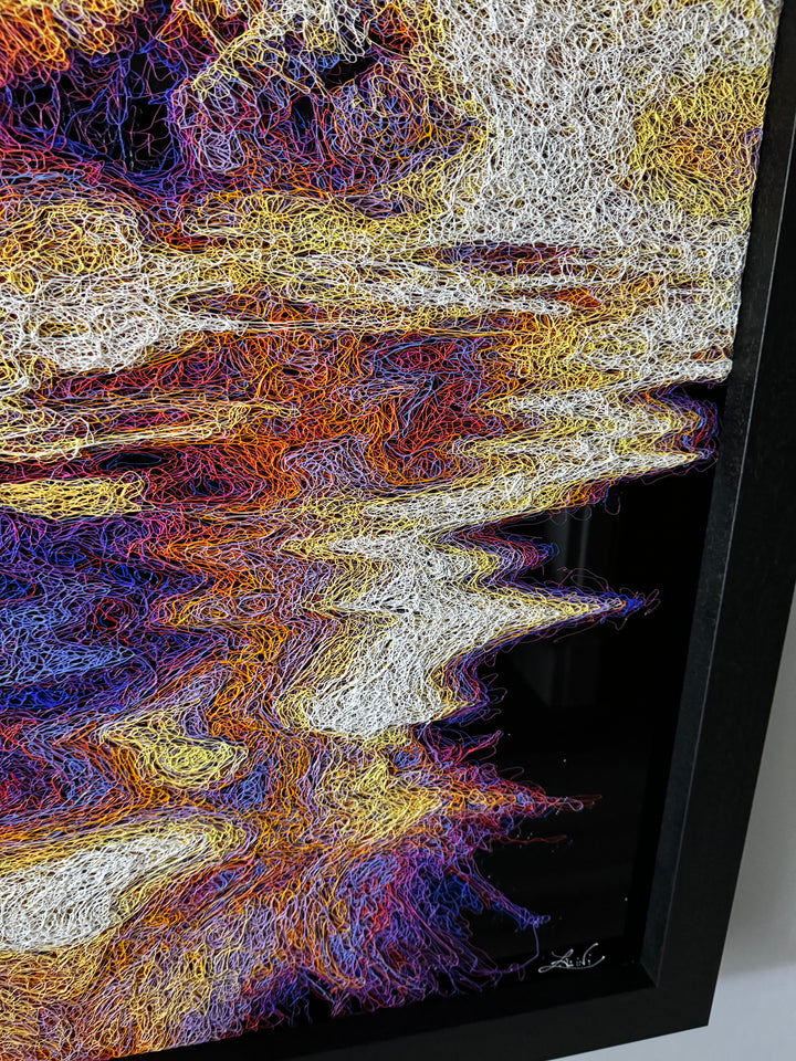 A vibrant textured artwork of a baby orangutan leaning over shimmering water, created with Zalini’s intricate injected-scribble technique, featuring flowing multicoloured lines, bright orange fur, vivid purples and blues, and a mirrored reflection across a glossy black surface.